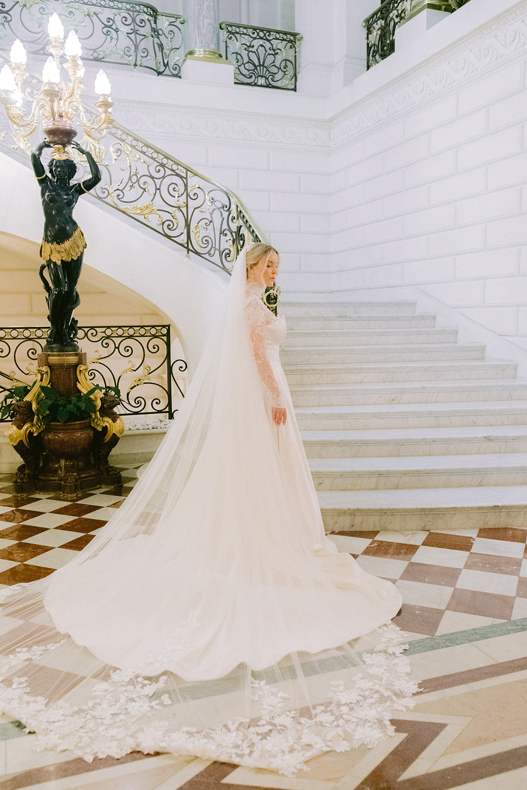 The bride poses in front of the steps